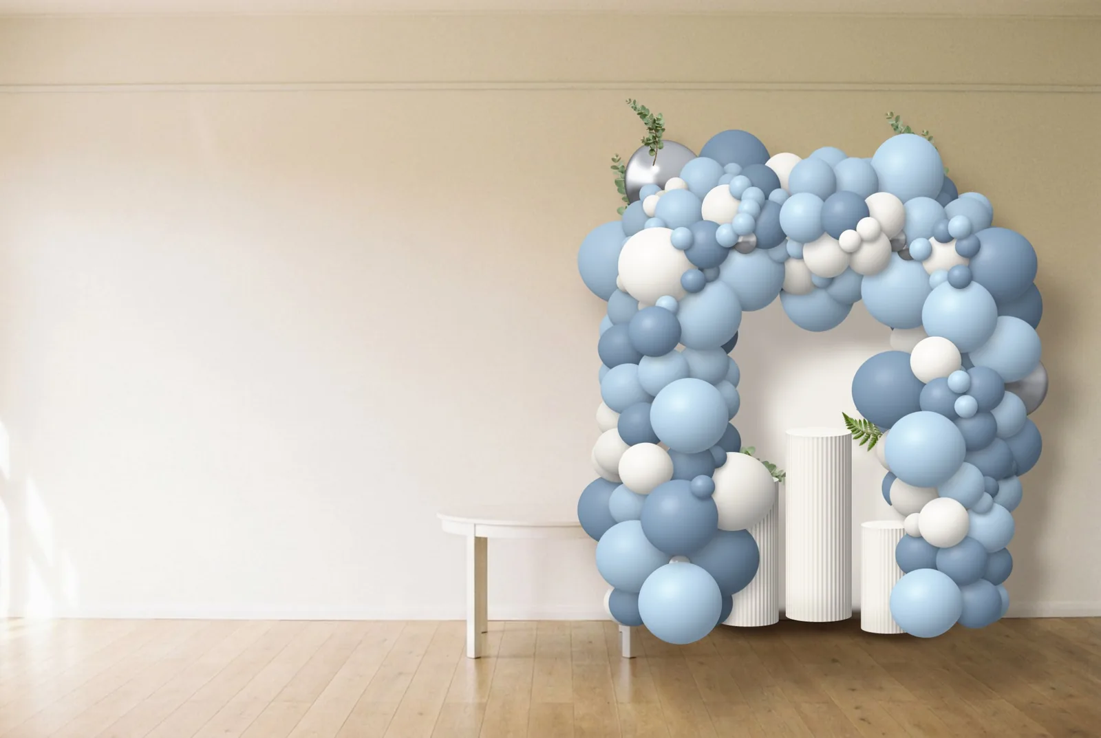 A framed balloon backdrop in baby blue, white and silver with three fluted pedestals and greenery, designed in Balloon Mockup Maker